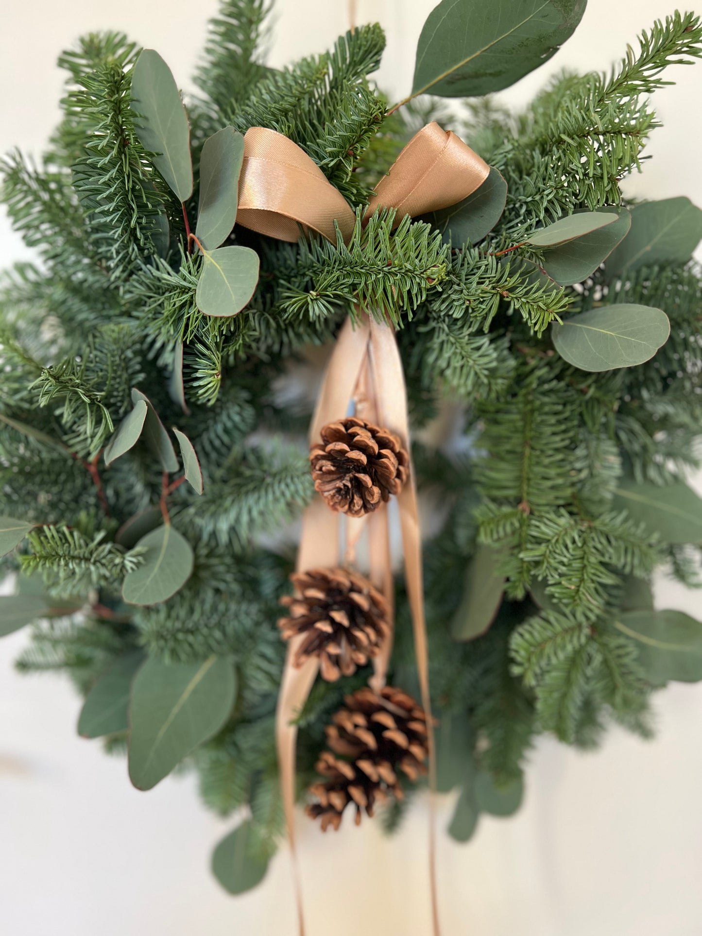 Christmas Wreath with Fresh Nordic Greenery, Eucalyptus, Pinecones, and Gold Ribbon
