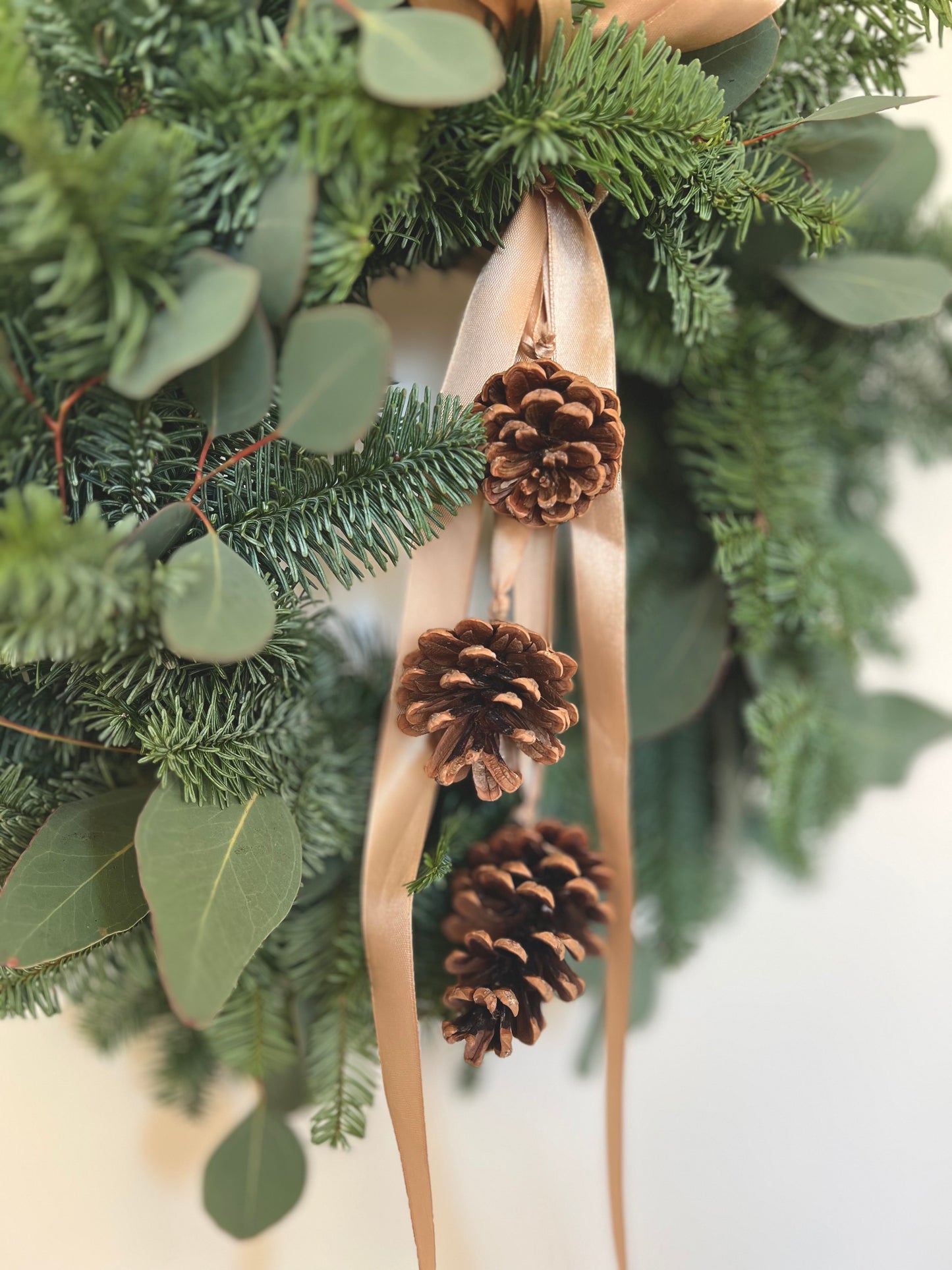 Christmas Wreath with Fresh Nordic Greenery, Eucalyptus, Pinecones, and Gold Ribbon